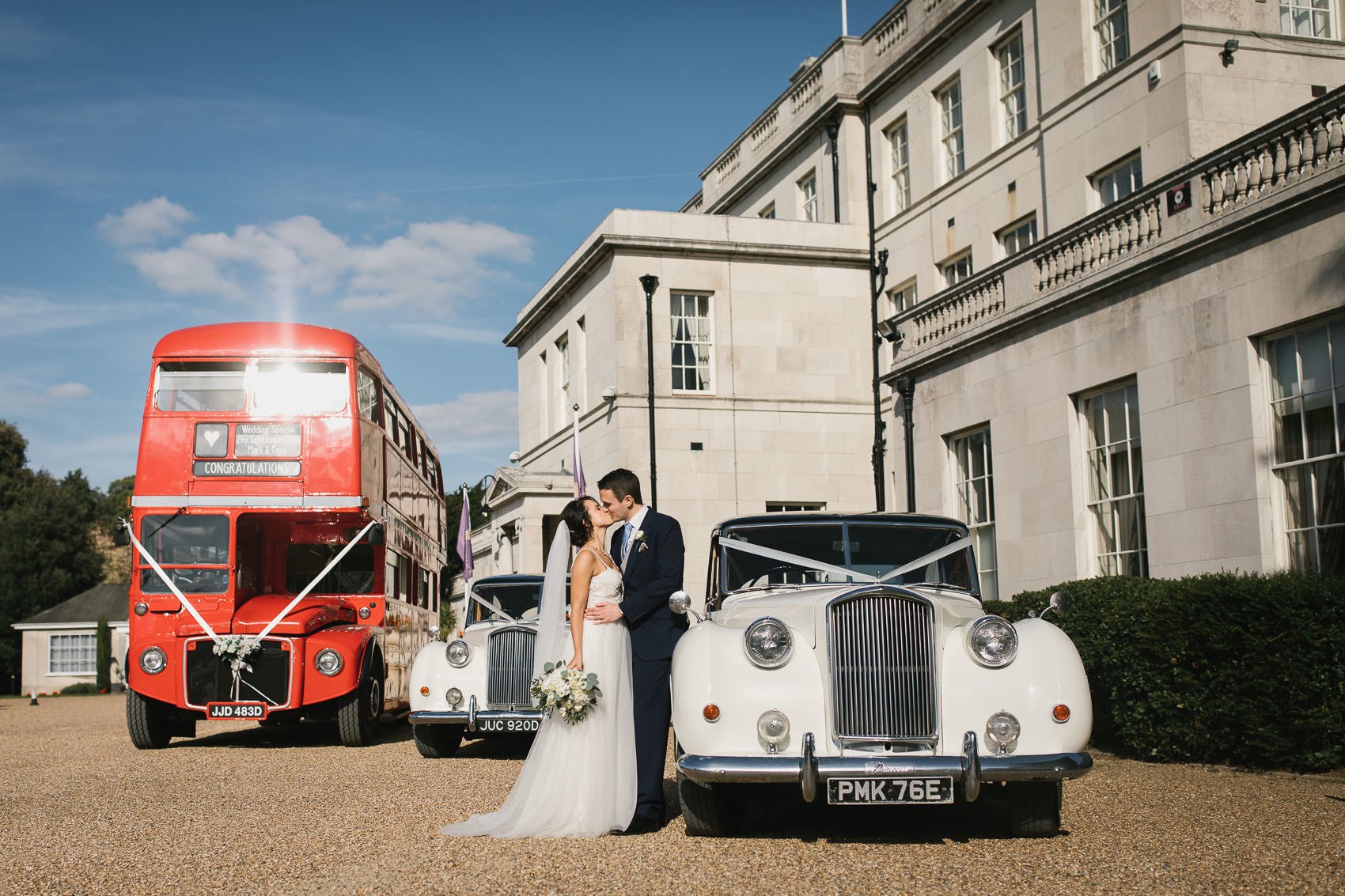 Bride and groom in front of car at Addington Palace