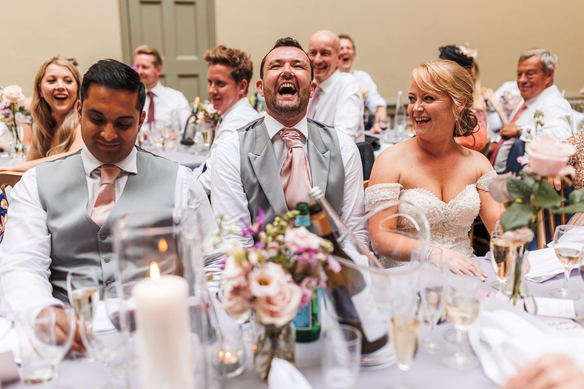 groom laughing at father of bride